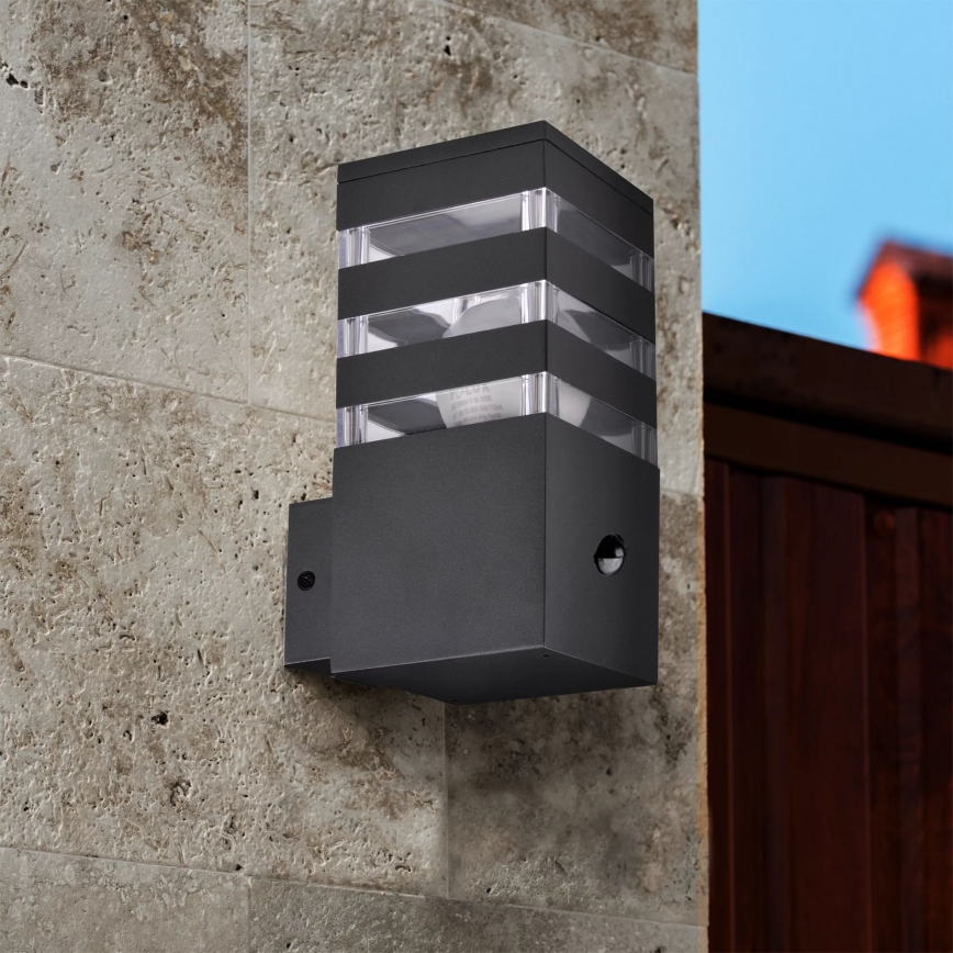 Iluminação de parede exterior com sensor TEKSAS 1xE27/12W/230V IP44 antracite