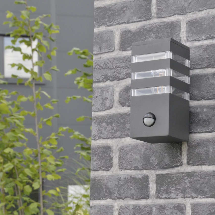Iluminação de parede exterior com sensor TEKSAS 1xE27/12W/230V IP44 antracite