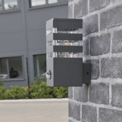 Iluminação de parede exterior com sensor TEKSAS 1xE27/12W/230V IP44 antracite