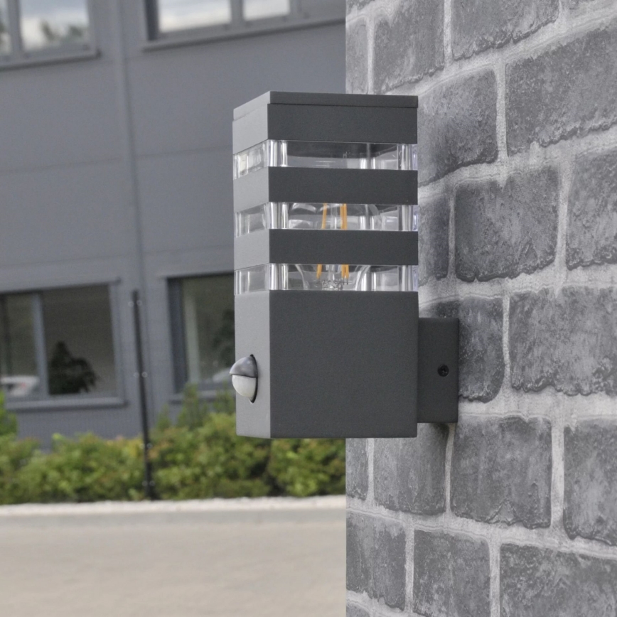 Iluminação de parede exterior com sensor TEKSAS 1xE27/12W/230V IP44 antracite