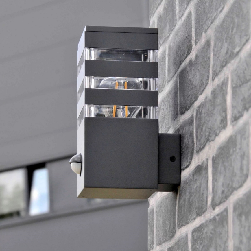 Iluminação de parede exterior com sensor TEKSAS 1xE27/12W/230V IP44 antracite