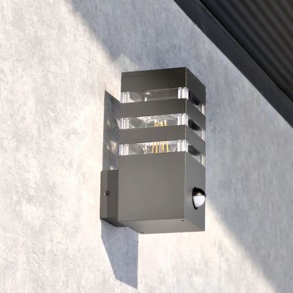Iluminação de parede exterior com sensor TEKSAS 1xE27/12W/230V IP44 antracite