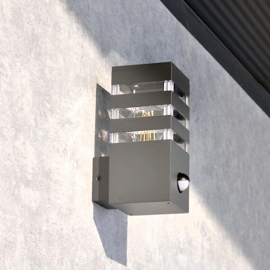 Iluminação de parede exterior com sensor TEKSAS 1xE27/12W/230V IP44 antracite
